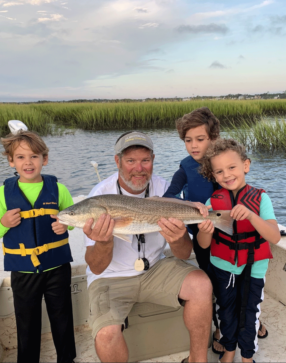 Captain Mike Hoffman and some junior anglers with a red drum