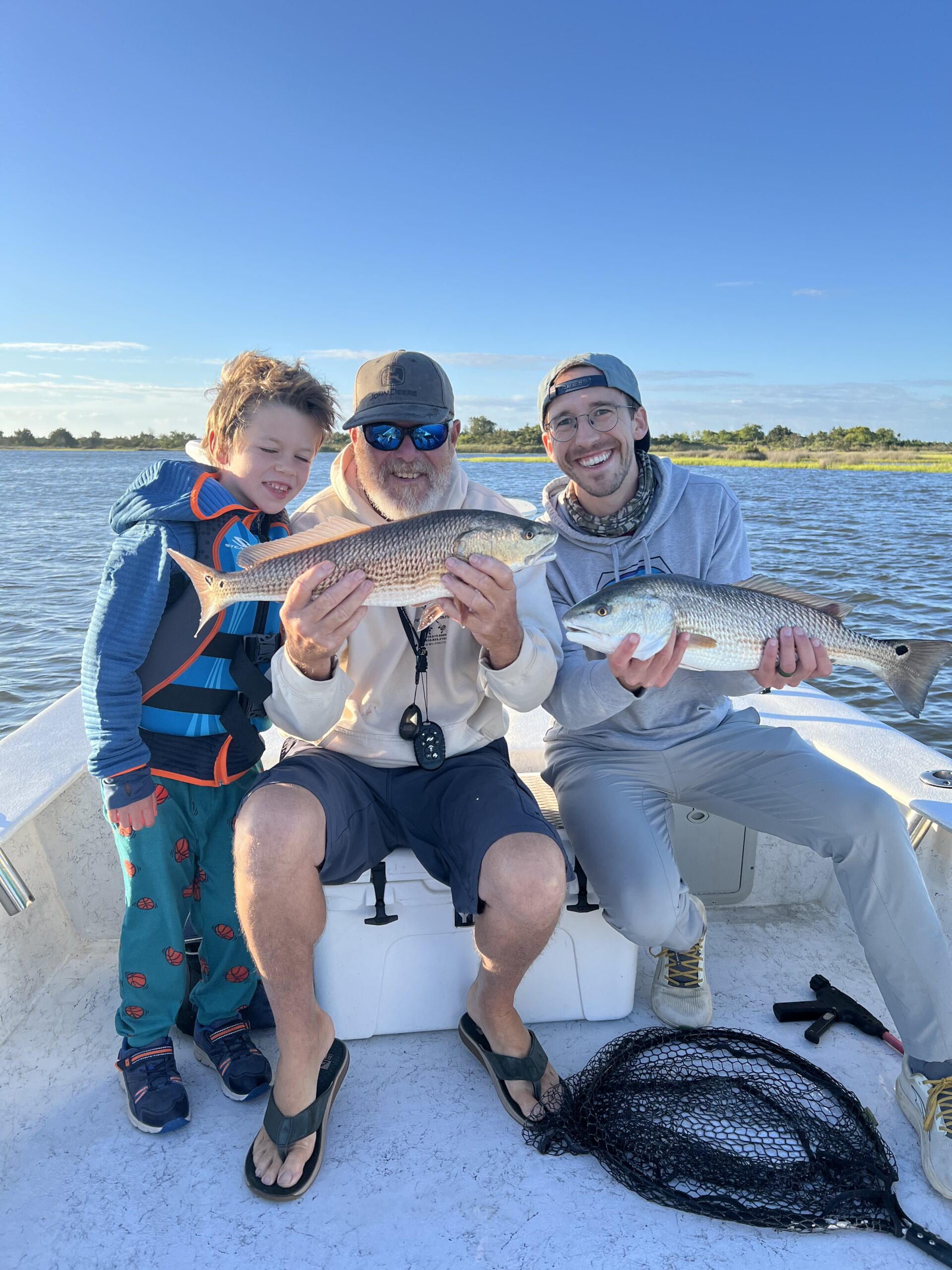 Captain Mike Hoffman of Topsail Island Fishing Guides on a family friendly fishing charter catching a few red drum fish.